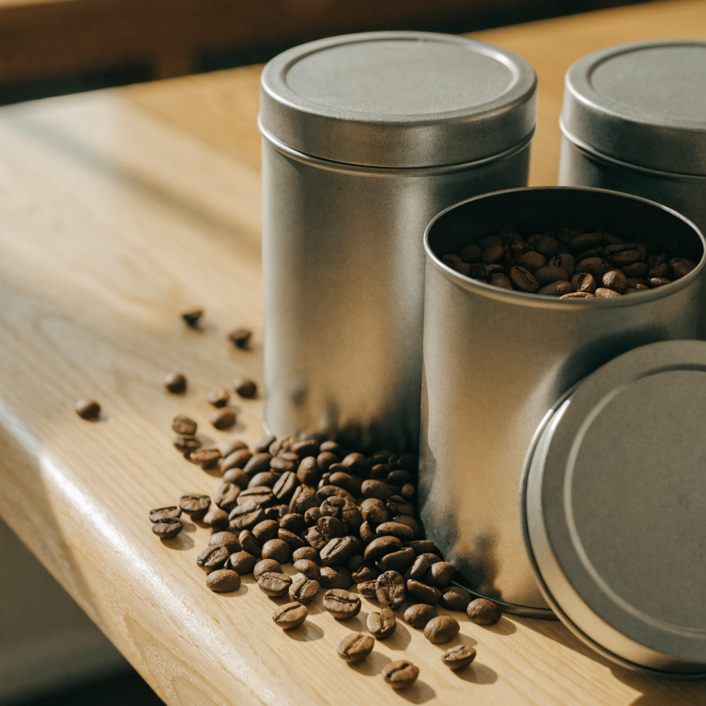 Steel coffee storage tins with roasted beans
