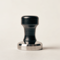 Calibrated espresso tamper with black aluminium handle and stainless base